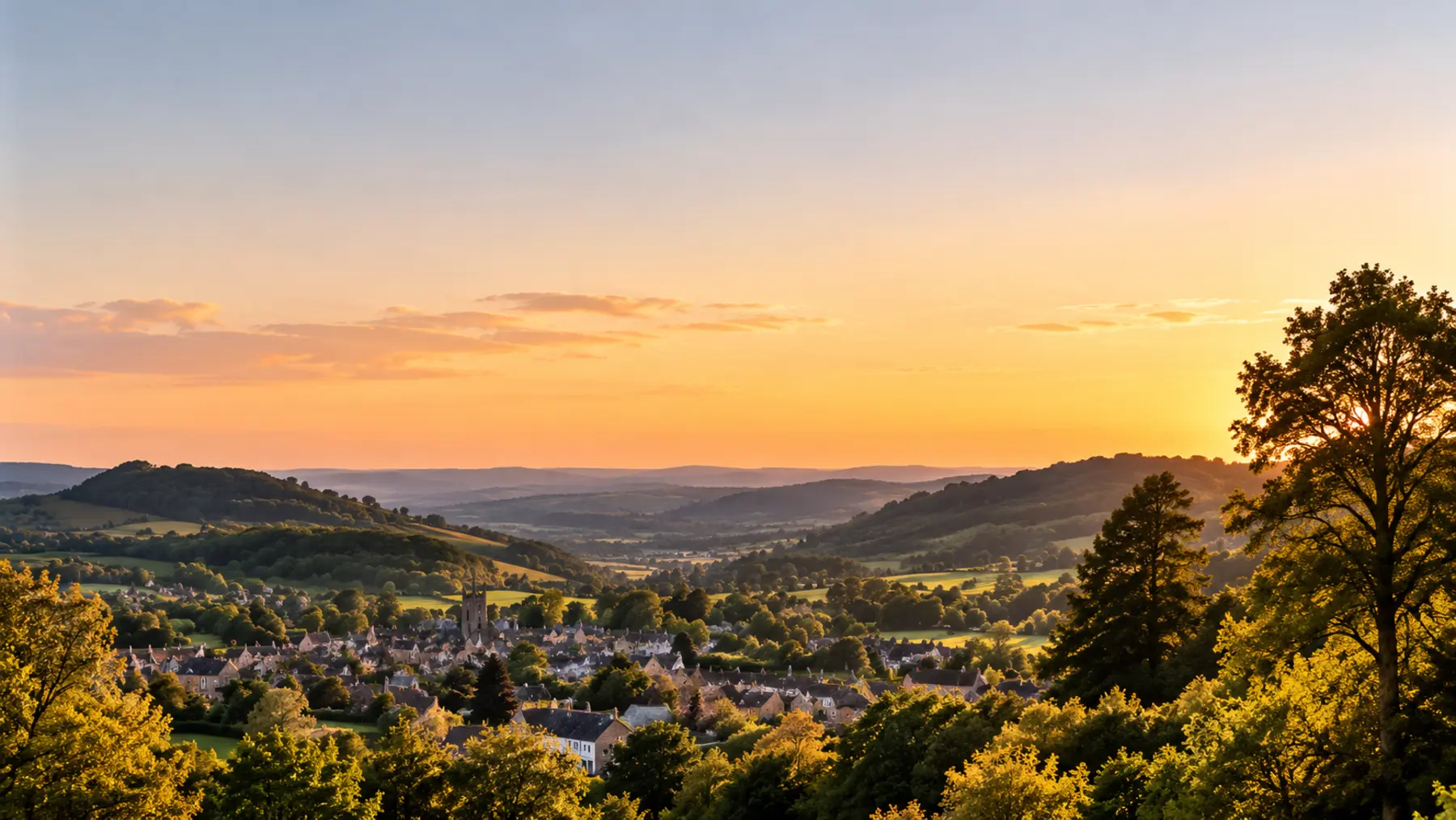 Golden evening light over an English village and surrounding countryside